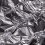 Close-up of shiny crumpled aluminum foil showcasing metallic wrinkled texture.