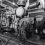 Black and white image of a vintage industrial engine inside a building.