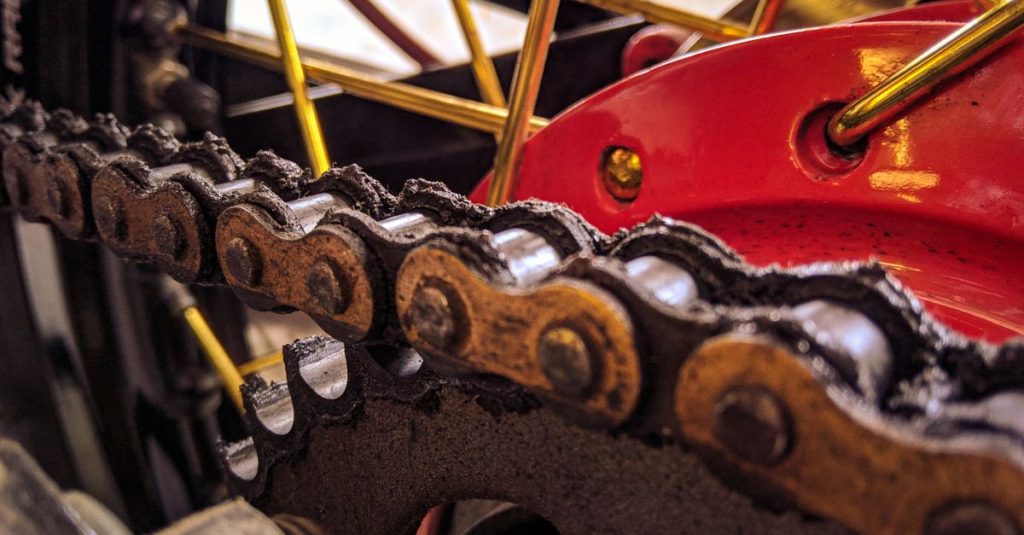 Closeup of bicycle transmission system with metal chain on hydraulic disk brake on wheel