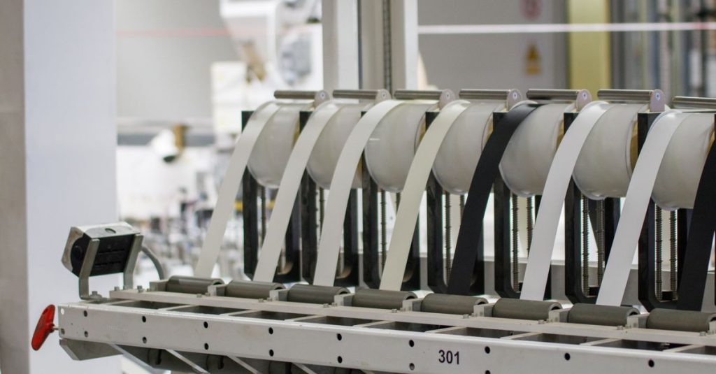 Modern industrial machine in operation in a manufacturing facility showcasing advanced technology.